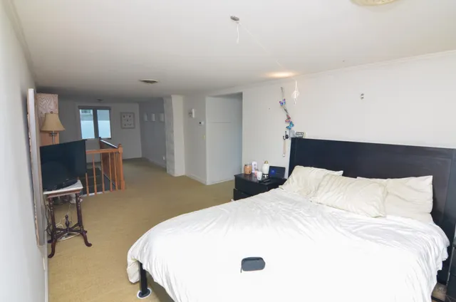 a bedroom with a bed and a chair