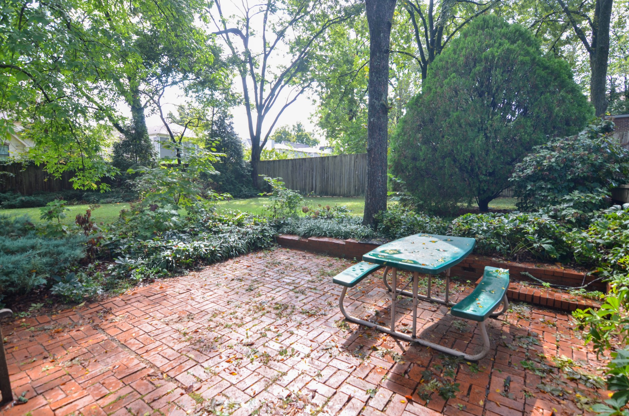 3434 Stokesmont Road Nashville, TN 37215 - Photo 26 of 29 a view of a backyard with table and chairs potted plants and large tree