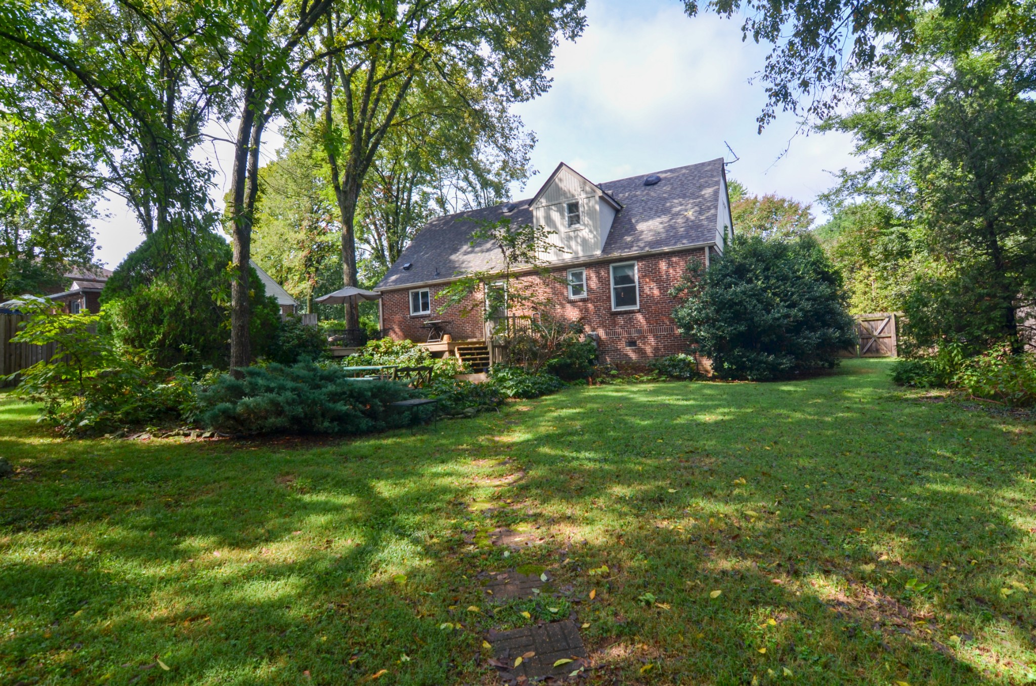 3434 Stokesmont Road Nashville, TN 37215 - Photo 28 of 29 a view of a big house with a big yard and large trees