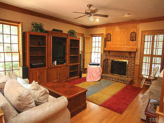 6116 Battleview Drive Raleigh, NC 27613 - Photo 6 of 13 a living room with furniture a flat screen tv and a fireplace