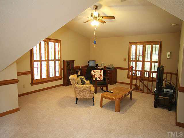 6116 Battleview Drive Raleigh, NC 27613 - Photo 8 of 13 a living room with furniture and a flat screen tv
