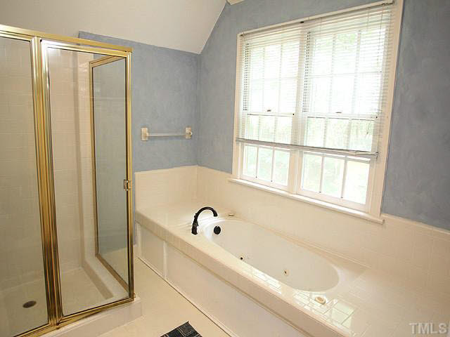 6116 Battleview Drive Raleigh, NC 27613 - Photo 10 of 13 a bathroom with a bathtub and a shower