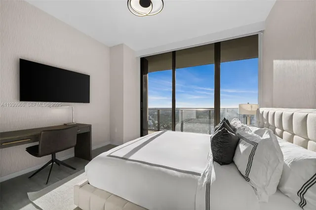 a living room with furniture and a view of kitchen