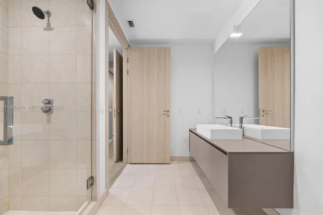 a living room kitchen with stainless steel appliances kitchen island granite countertop a couch and a dining table with wooden floor