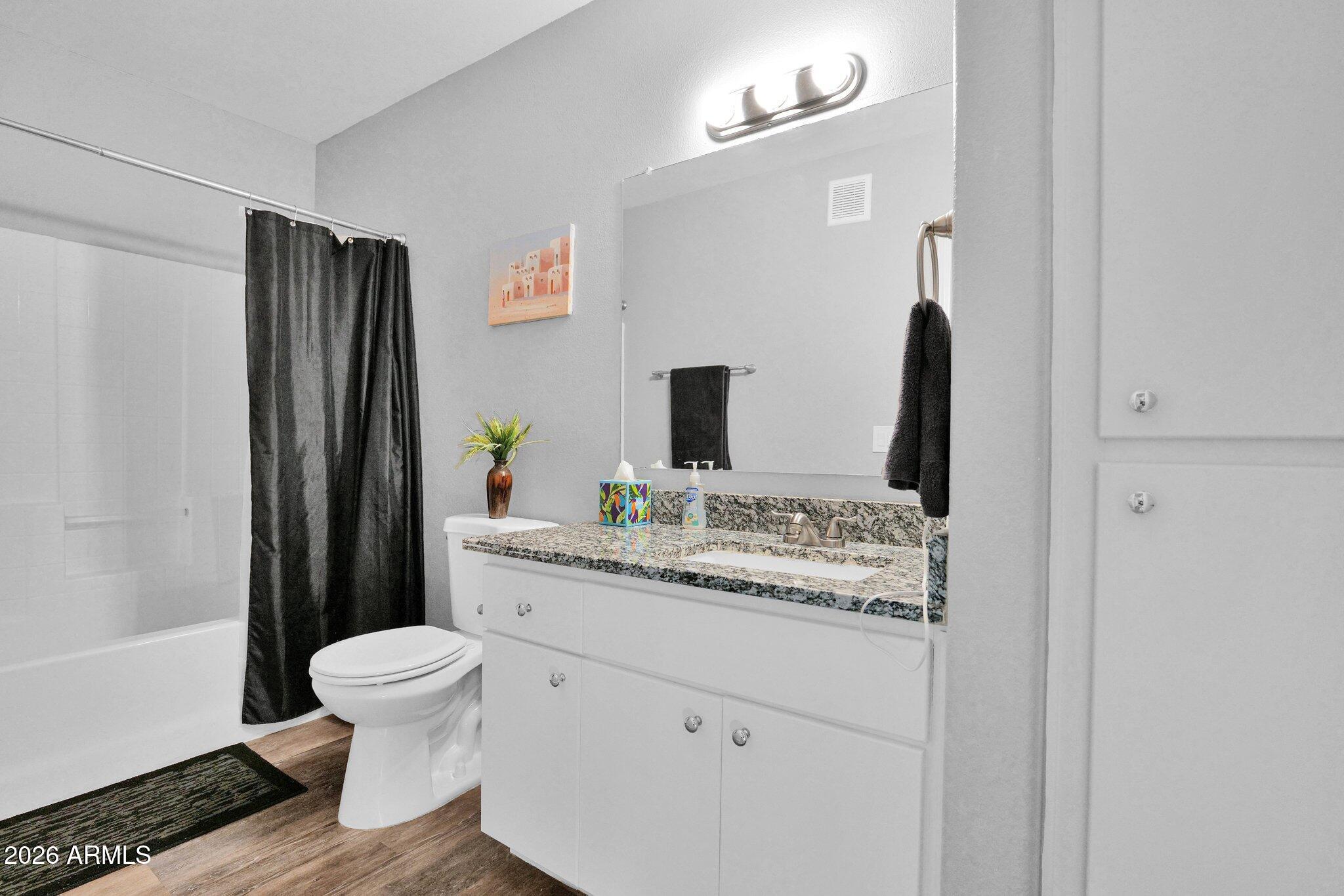 1295 North Ash Street, Unit 624 Gilbert, AZ 85233 - Photo 19 of 39 a bathroom with a granite countertop sink toilet and shower