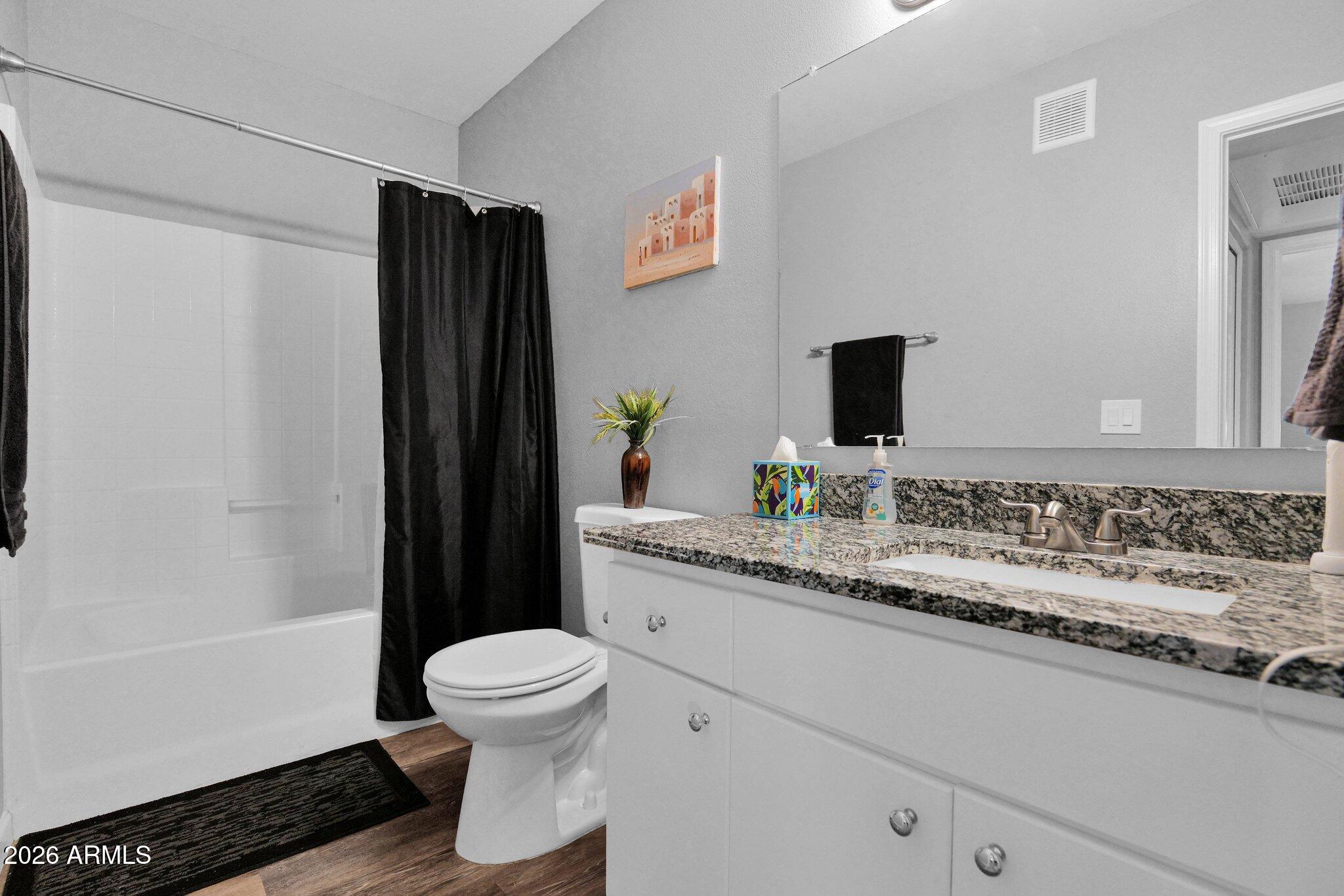 1295 North Ash Street, Unit 624 Gilbert, AZ 85233 - Photo 20 of 39 a bathroom with a granite countertop sink toilet and shower