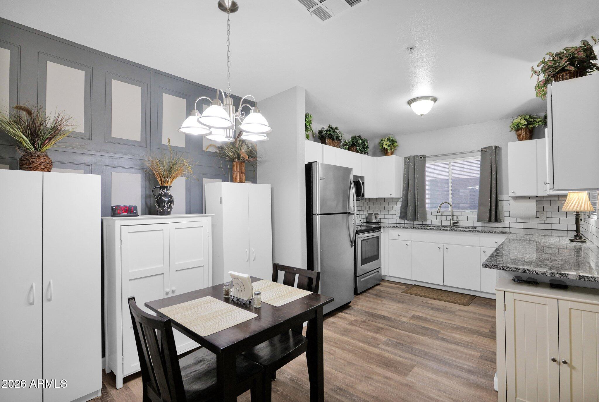 1295 North Ash Street, Unit 624 Gilbert, AZ 85233 - Photo 5 of 39 a kitchen with refrigerator and cabinets