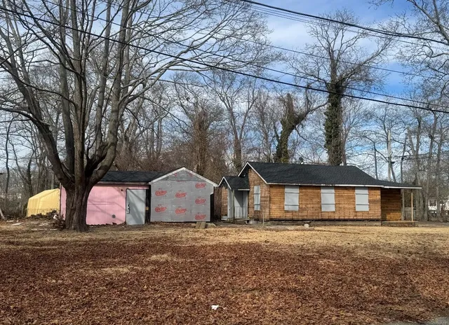 a house that has a tree in front of it