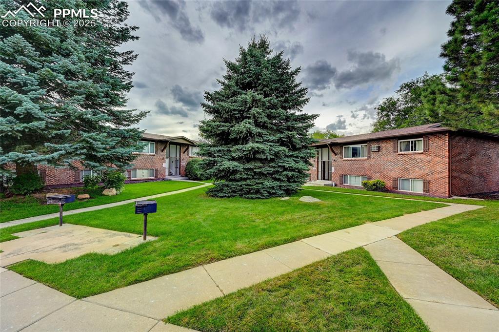 6633 Dublin Loop West, Unit 4 Colorado Springs, CO 80918 - Photo 14 of 33 a view of a house with a yard