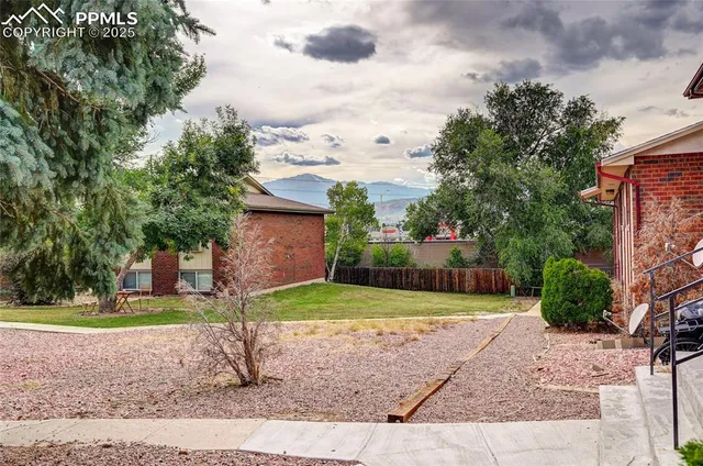 a view of house with a yard