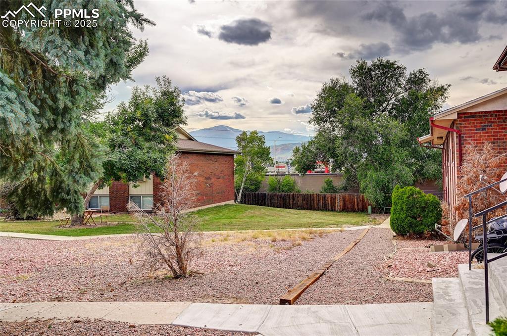 6633 Dublin Loop West, Unit 4 Colorado Springs, CO 80918 - Photo 18 of 33 a view of a backyard with large trees