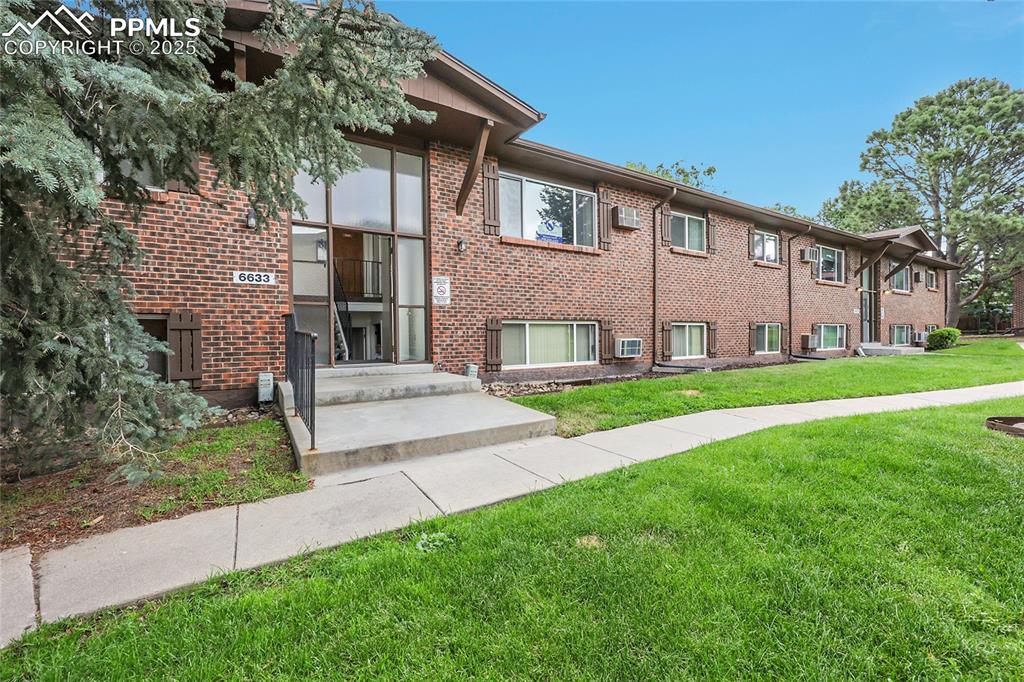 6633 Dublin Loop West, Unit 4 Colorado Springs, CO 80918 - Photo 19 of 33 a view of house with a yard