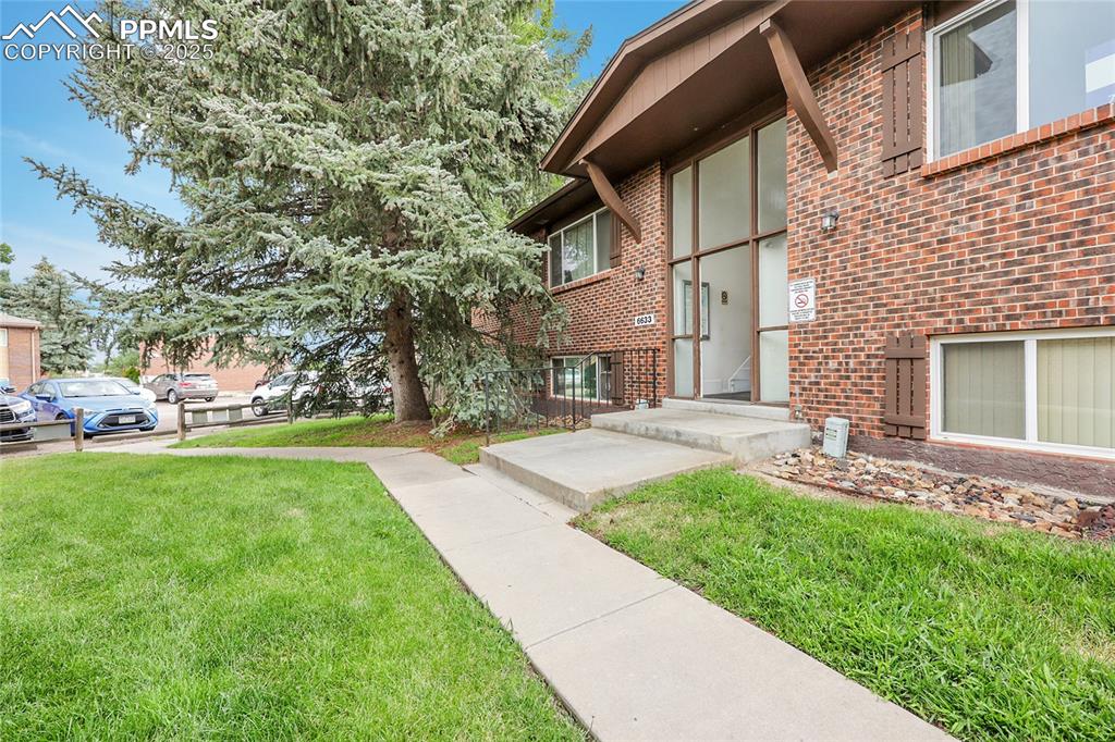 6633 Dublin Loop West, Unit 4 Colorado Springs, CO 80918 - Photo 20 of 33 a view of a front of a house with a yard
