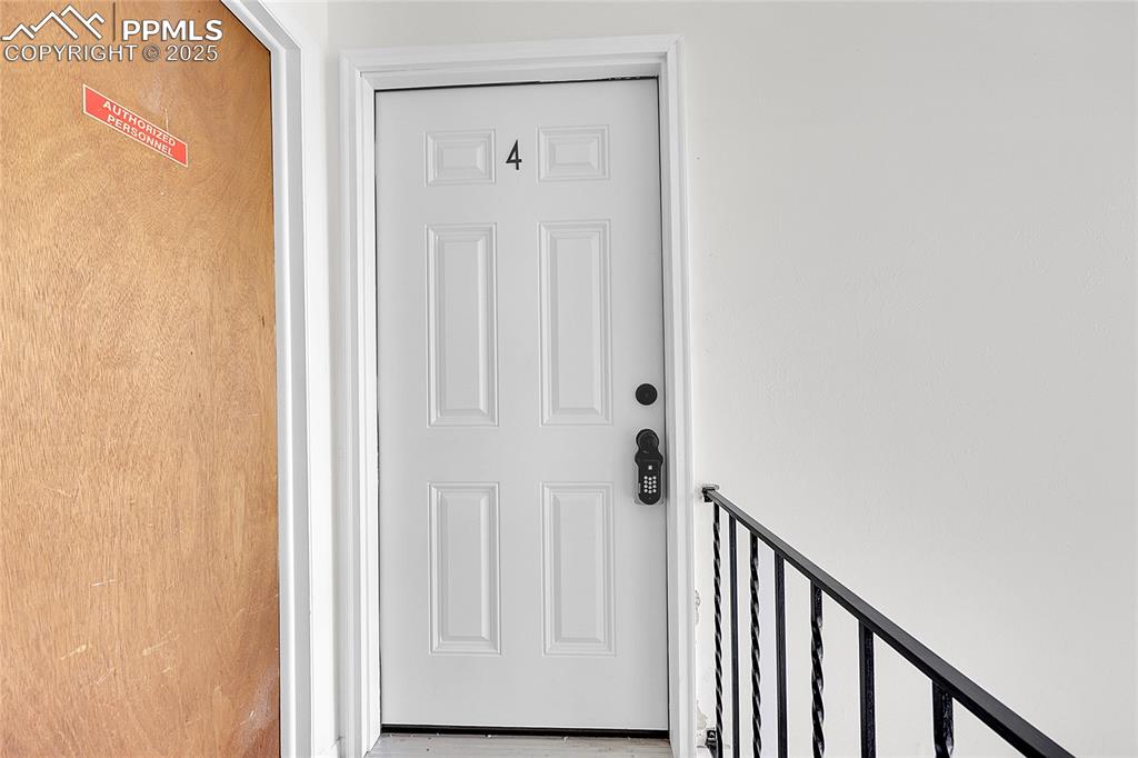 6633 Dublin Loop West, Unit 4 Colorado Springs, CO 80918 - Photo 21 of 33 a view of a hallway with wooden floor