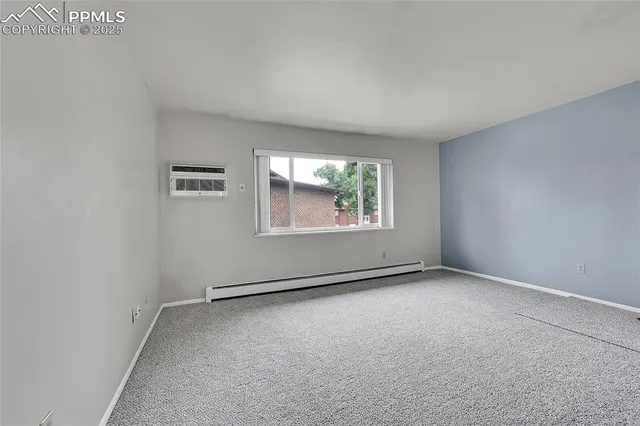 a kitchen with a white cabinets and wooden floor