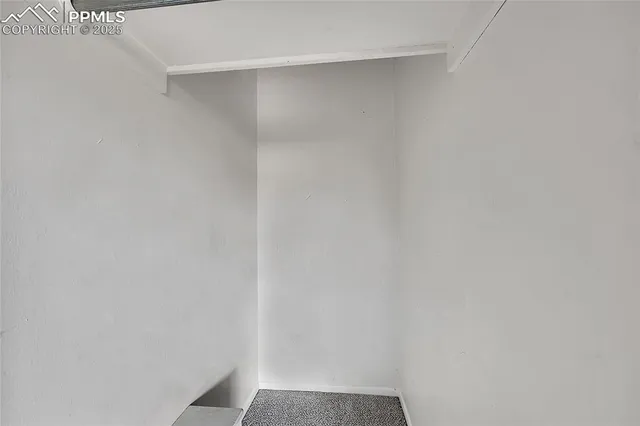 a kitchen with a refrigerator stove and white cabinets