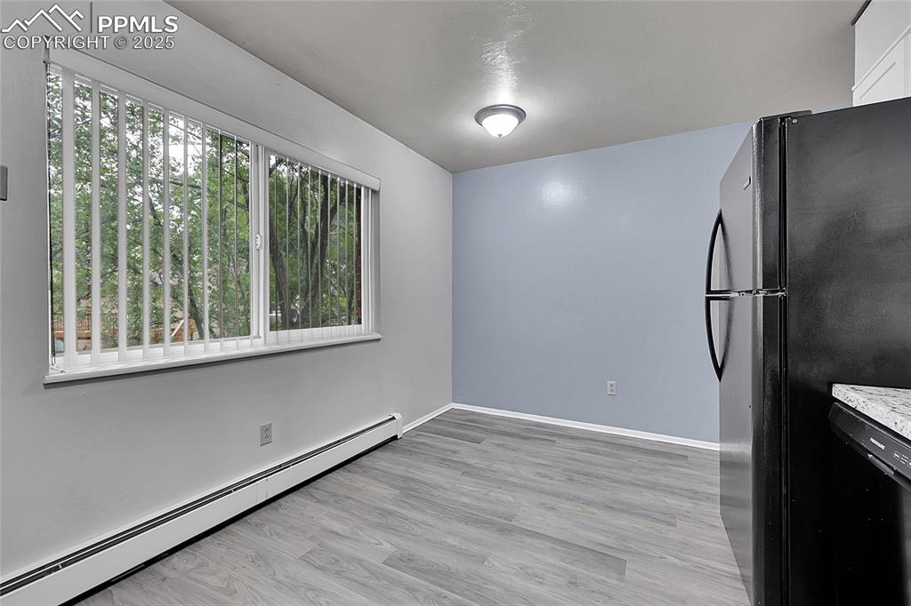 6633 Dublin Loop West, Unit 4 Colorado Springs, CO 80918 - Photo 27 of 33 a view of empty room with wooden floor and fan