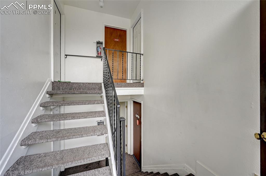 6633 Dublin Loop West, Unit 4 Colorado Springs, CO 80918 - Photo 5 of 33 a view of staircase with white walls and windows