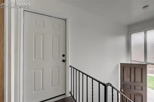 a view of a hallway with wooden floor and entryway