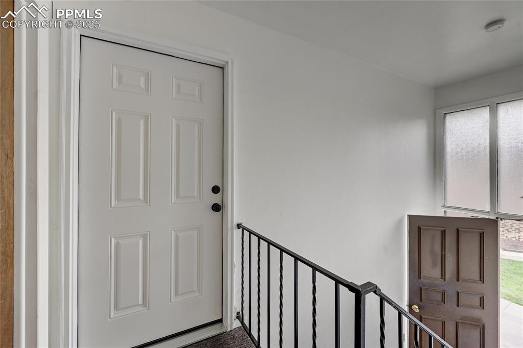 6633 Dublin Loop West, Unit 4 Colorado Springs, CO 80918 - Photo 6 of 33 a view of a hallway with wooden floor and entryway