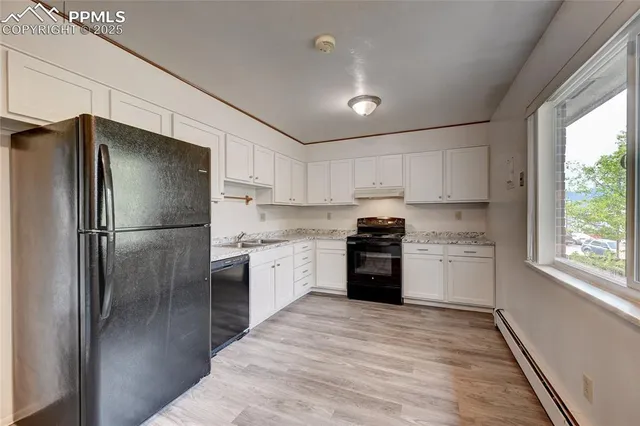 a kitchen with granite countertop stainless steel appliances a refrigerator sink and microwave
