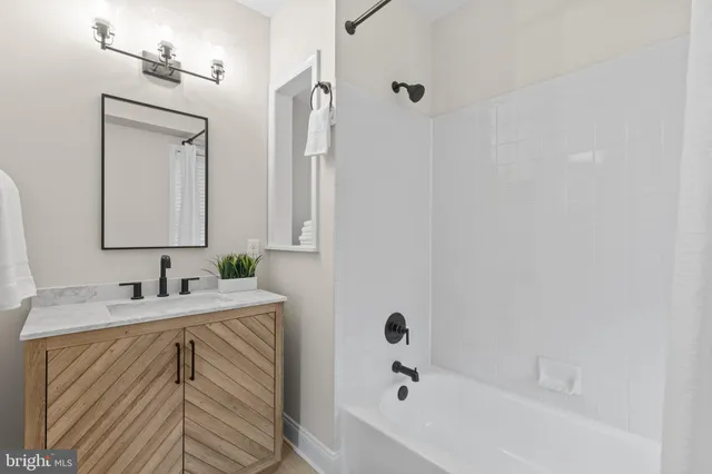 a bedroom with bed and ceiling fan