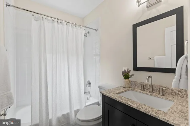 an outdoor sitting area with furniture and wooden floor