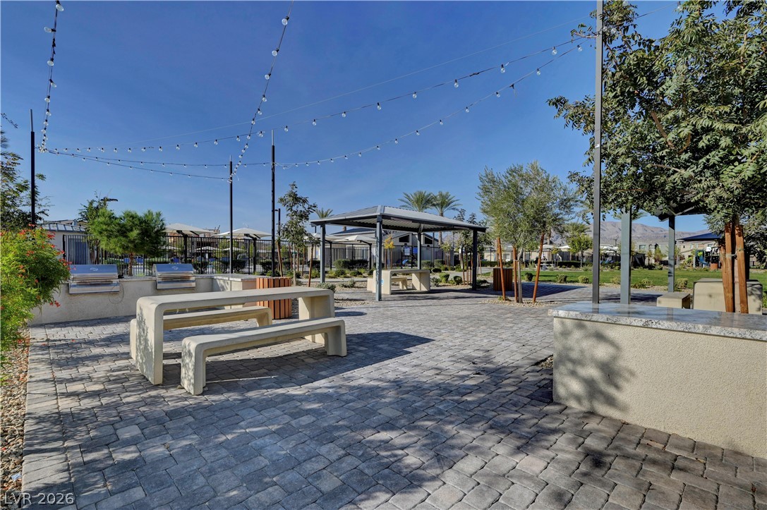 6924 Spicy Merlot Street North Las Vegas, NV 89086 - Photo 76 of 83 An inviting outdoor gathering space boasts built-in barbecue grills and shaded seating areas for community enjoyment.