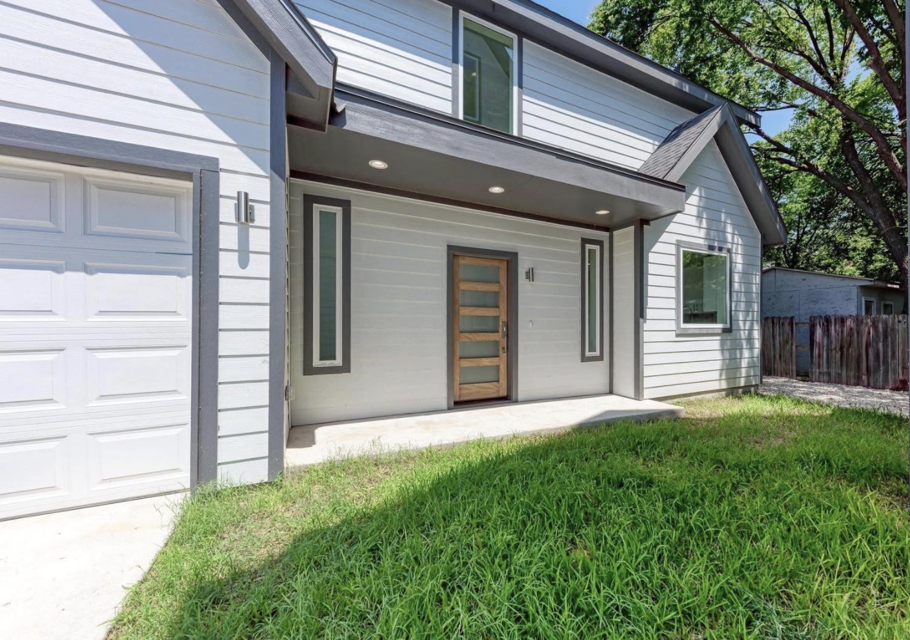 502 Tillery Street, Unit 2 Austin, TX 78702 - Photo 1 of 15 a front view of a house with a yard and garage