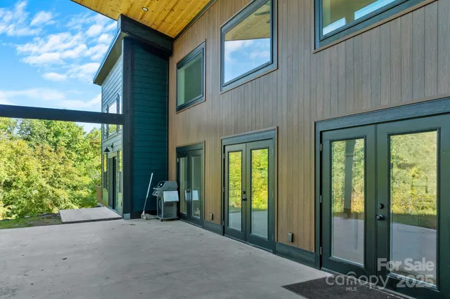 a view of a brick house with large windows