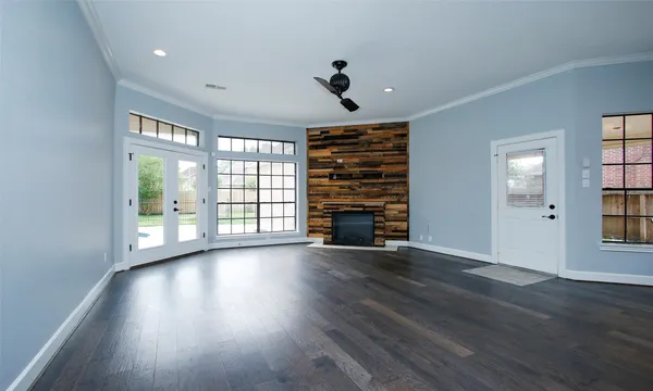 wooden floor in an empty room with a window