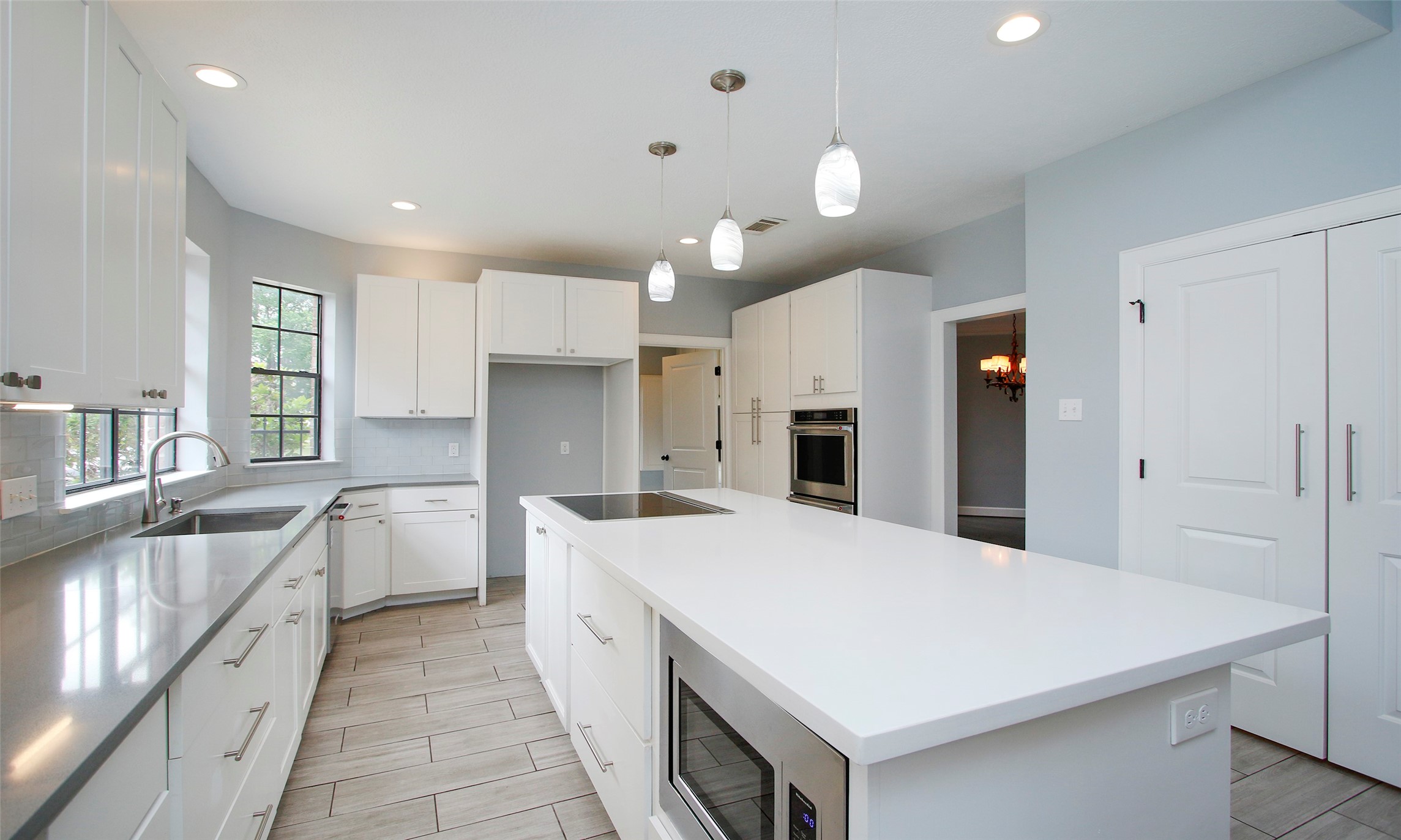 16119 Cochet Spring Drive Spring, TX 77379 - Photo 17 of 26 The kitchen features a stylish island, beautifully complemented by elegant drop lights overhead, adding both function and charm to the space.