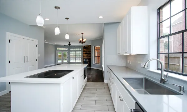 a kitchen with a sink cabinets and window