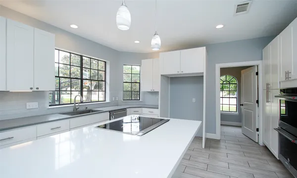 a kitchen with stainless steel appliances granite countertop a sink window and refrigerator