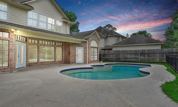 a view of pool with a yard