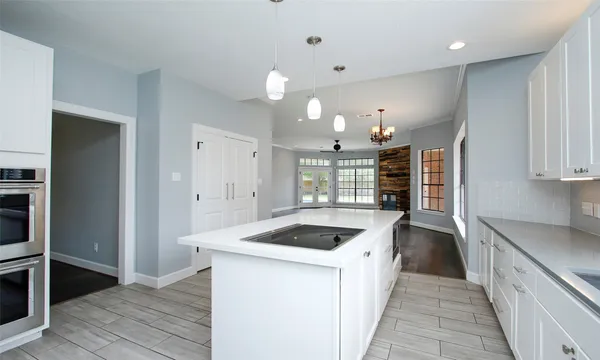 a kitchen with granite countertop a sink and cabinets