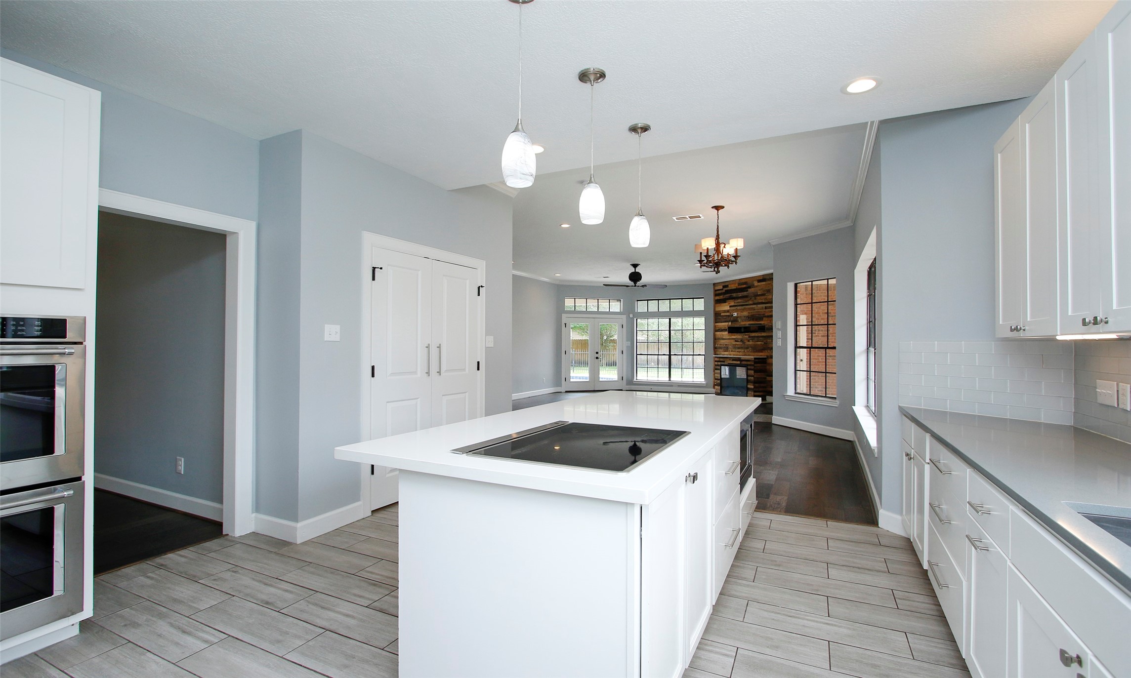 16119 Cochet Spring Drive Spring, TX 77379 - Photo 21 of 26 An additional view of the kitchen highlights its open connection to the family room; the closed door leads to the pantry for added storage.