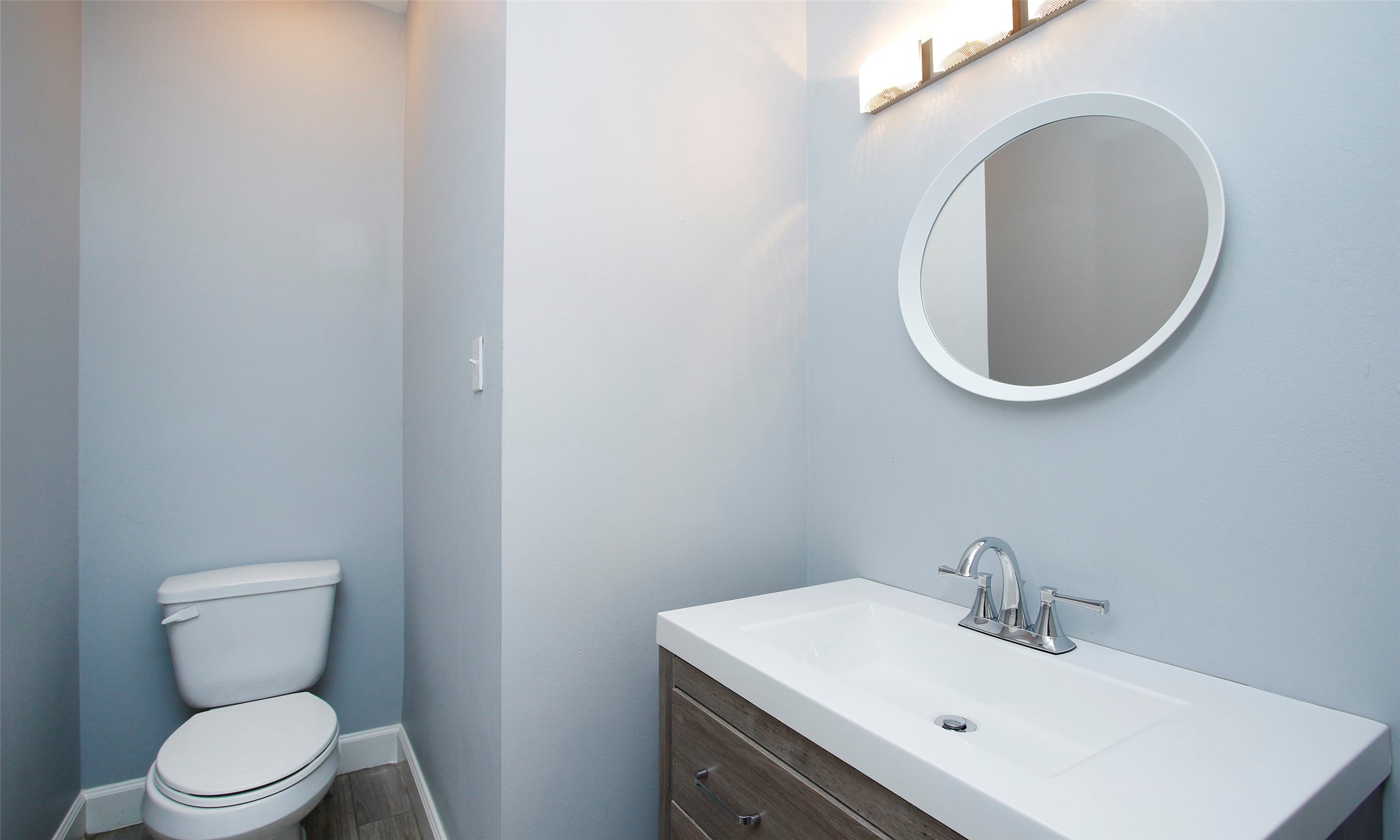 16119 Cochet Spring Drive Spring, TX 77379 - Photo 25 of 26 The half bathroom features serene powder blue walls, creating a calm and refreshing atmosphere.
