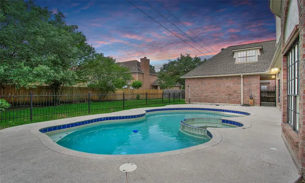 a view of a backyard with a swimming pool and deck