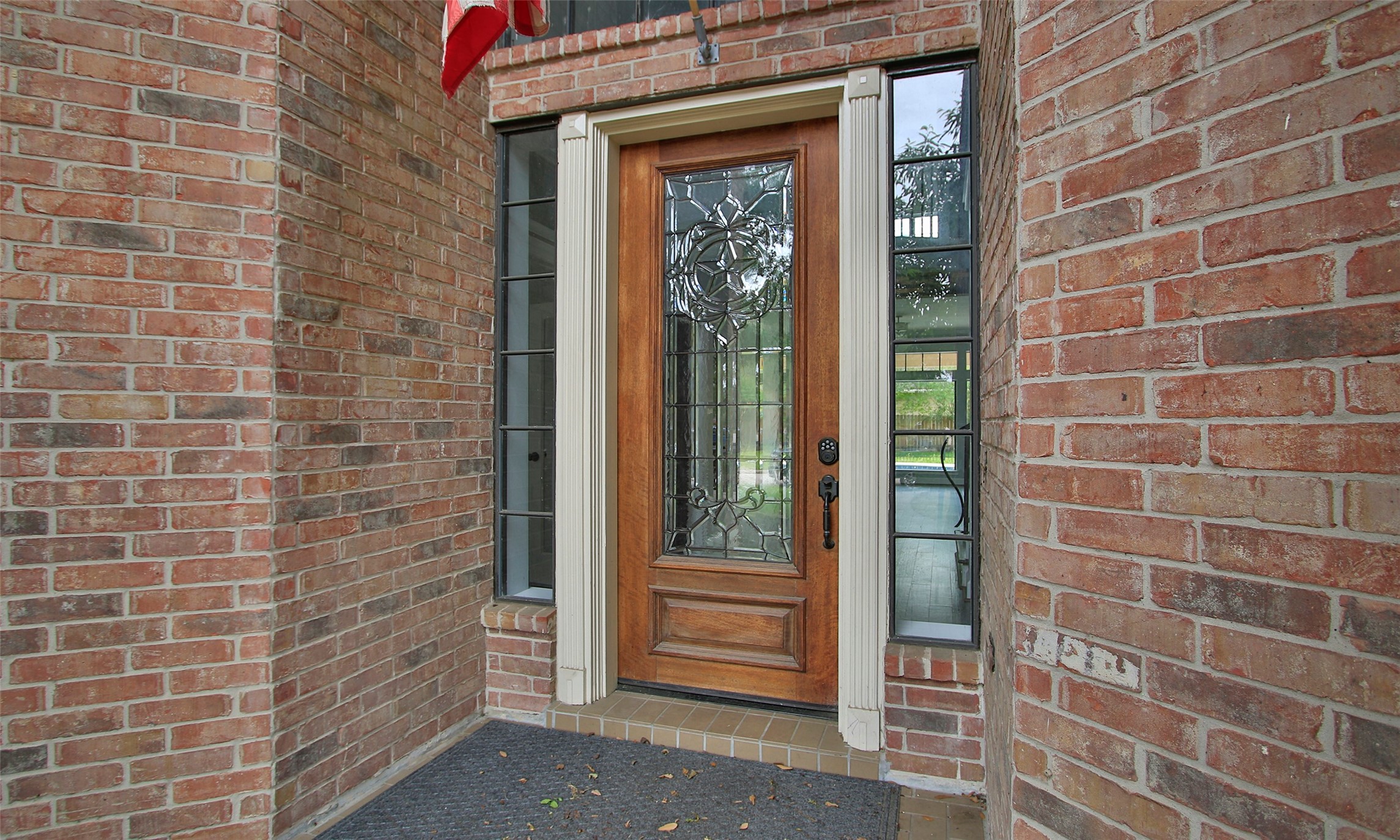 16119 Cochet Spring Drive Spring, TX 77379 - Photo 6 of 26 The main door showcases a stylish wooden frame with a glass center, blending elegance and natural light.