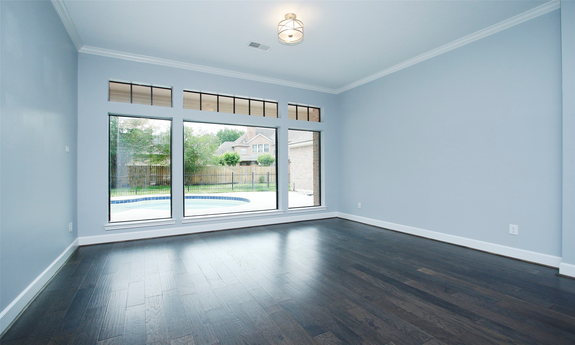 16119 Cochet Spring Drive Spring, TX 77379 - Photo 9 of 26 A cozy sitting area with expansive glass windows, offering a beautiful view of the lush backyard.