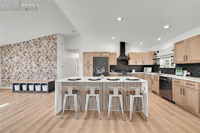 a kitchen with stainless steel appliances granite countertop a white cabinets and wooden floor
