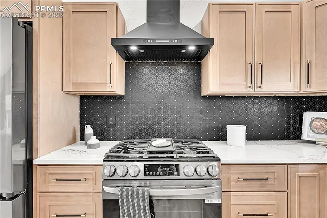 a stove top oven sitting inside of a kitchen