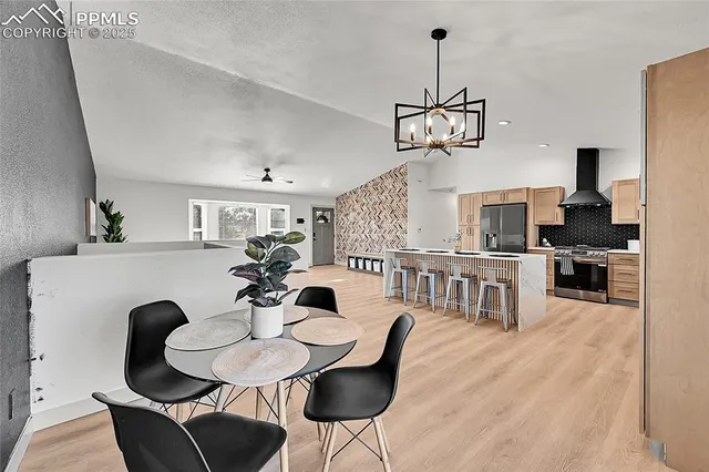 a view of a dining room with furniture wooden floor and chandelier