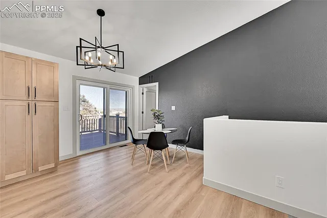 a view of a livingroom with furniture wooden floor and chandelier