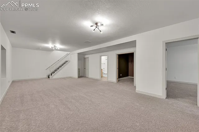 a view of an empty room with a fireplace