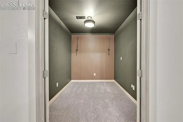 an empty room with closet and windows