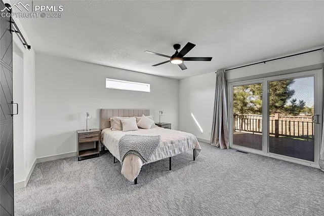 a spacious bedroom with a bed and a large window