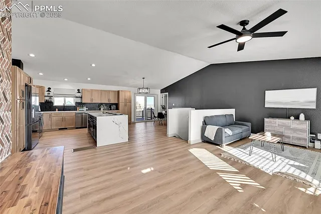 a living room with furniture and kitchen view