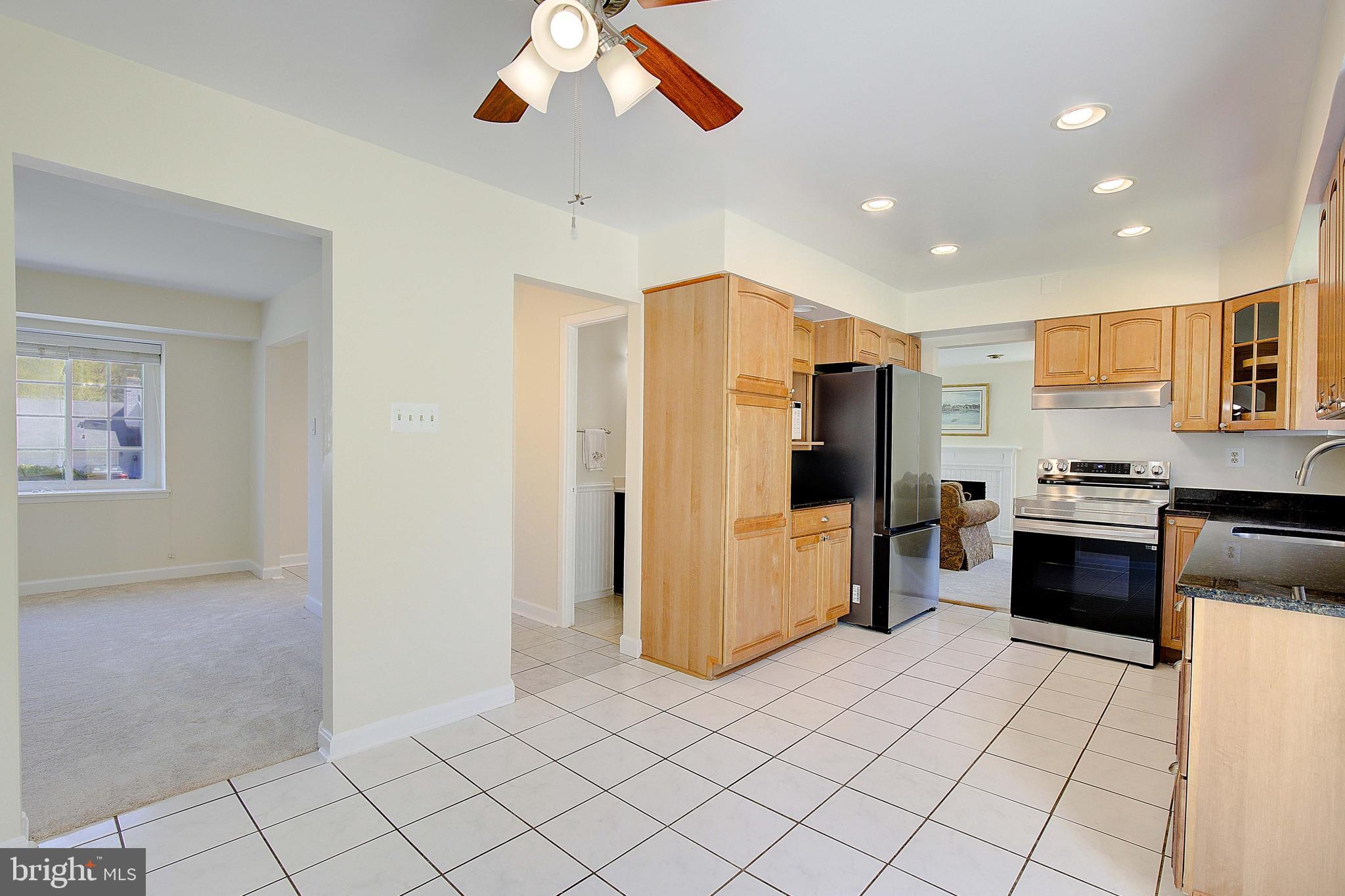 12702 Cedarbrook Lane Laurel, MD 20708 - Photo 11 of 43 a kitchen with stainless steel appliances granite countertop a refrigerator and a stove top oven